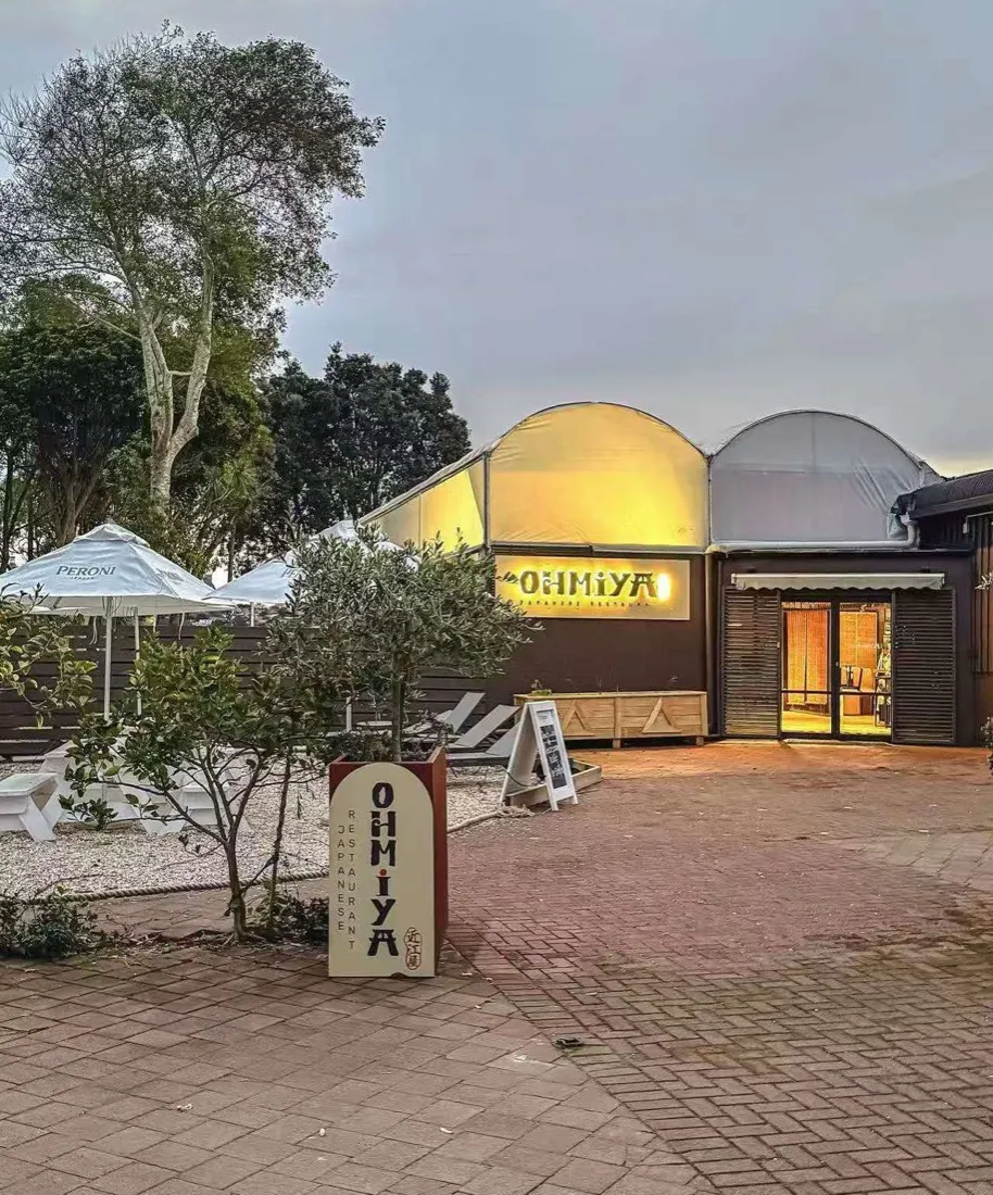 OHMIYA Japanese Restaurant entrance at dusk, with the lit sign and courtyard on Orakei Road, Remuera